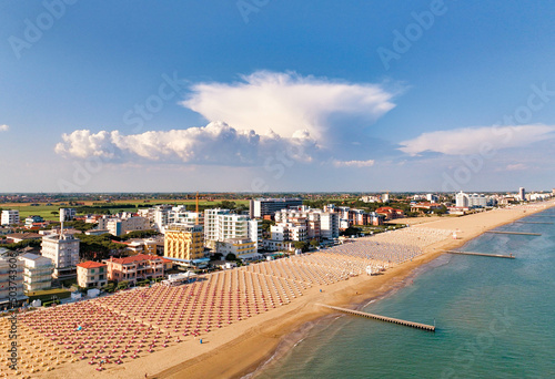 Jesolo - spiaggia con lettini  e ombrelloni in località estiva vista dall'alto con vista sulla città photo