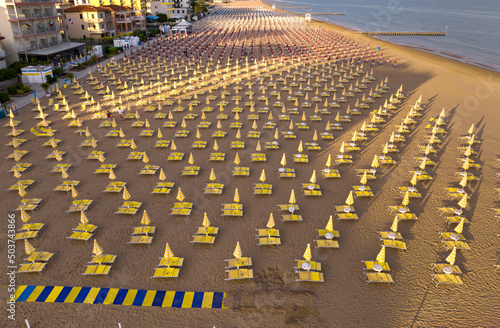 Jesolo - spiaggia con lettini  e ombrelloni in località estiva vista dall'alto con vista sulla città photo