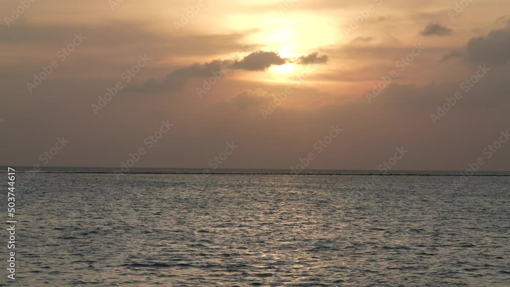 Sunset over ocean with beautiful clounds. Amazing color of the sky. Calm water surface near tropic islandnobody nature seascape. Paradise island Sunset over ocean with beautiful clounds. Amazing color of the sky. Calm water surface near tropic islandnobody nature seascape. Paradise island
