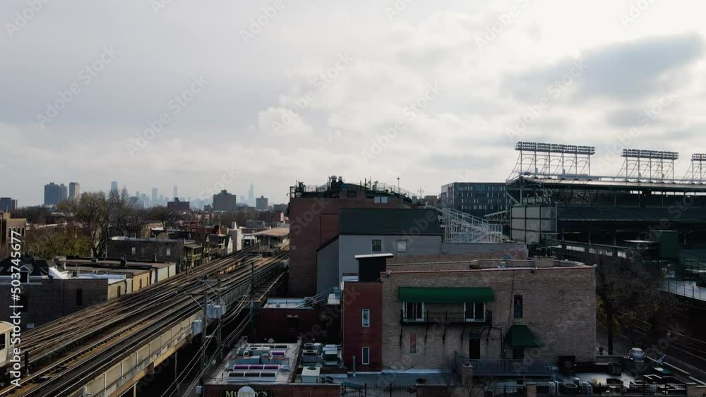 Aerial view of the Addision station with Chicago skyline background - ascending, drone shot Aerial view of the Addision station with Chicago skyline background - ascending, drone shot