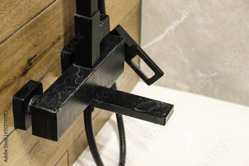 Wallpaper Mural Black faucet with limescale deposits due to water hardness close-up Torontodigital.ca