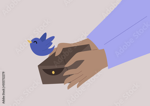 Hands opening an empty wallet, a bird flies out of it, financial troubles, no cash