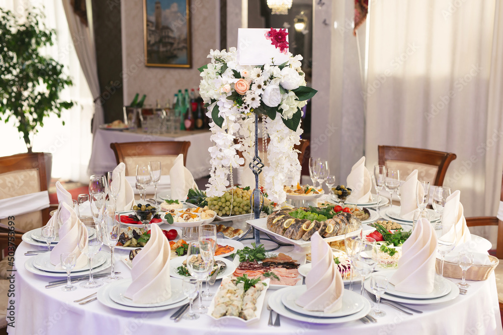 Served wedding banquet table with dishes in the restaurant
