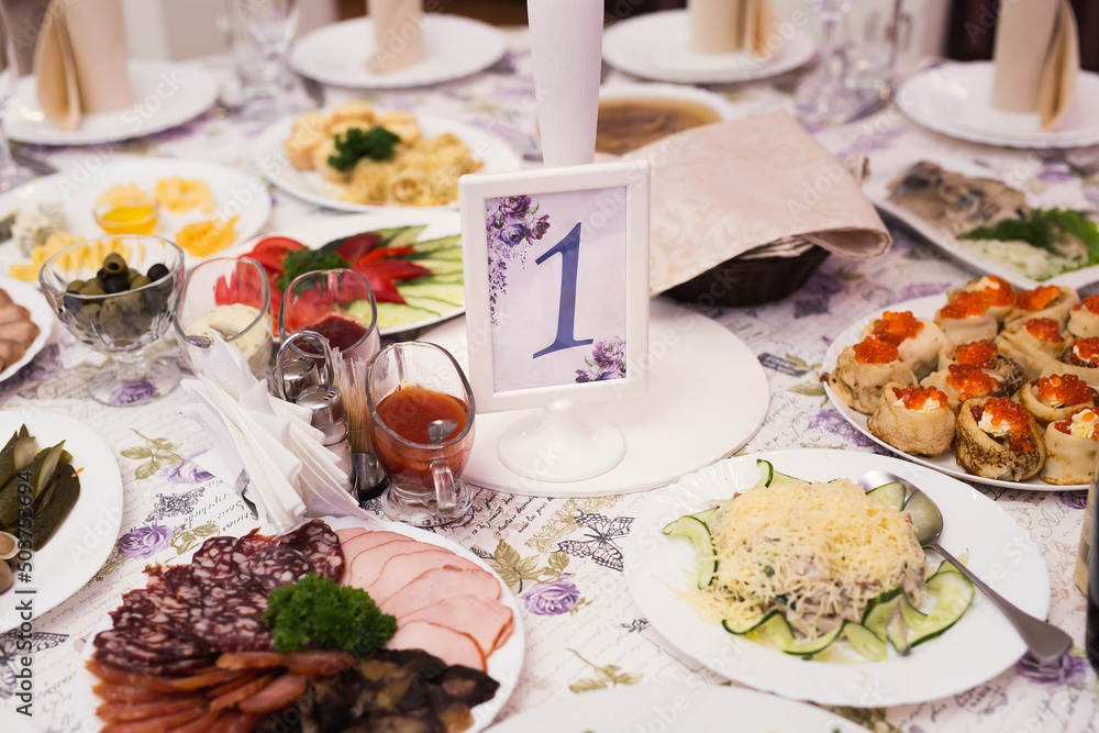Served wedding banquet table with dishes in the restaurant Served wedding banquet table with dishes in the restaurant