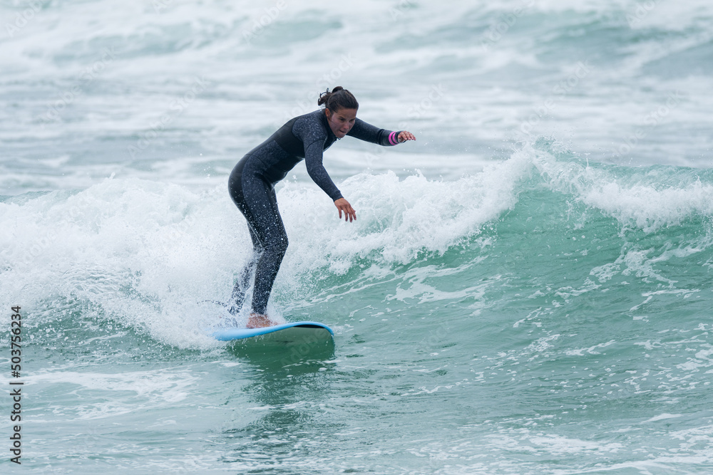 Surfer girl riding a wave