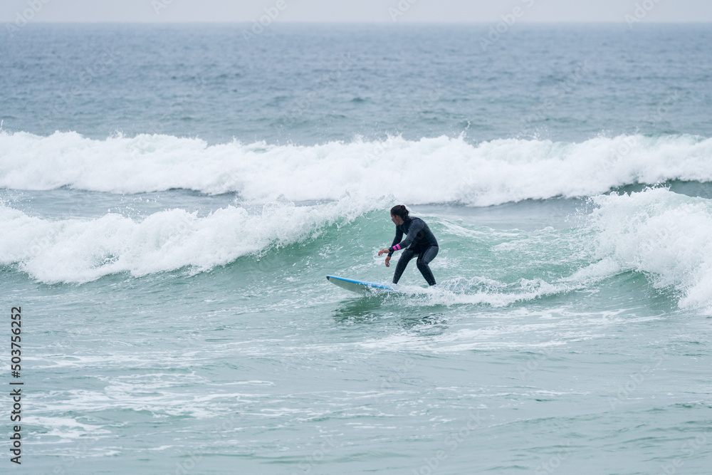 Surfer girl riding a wave