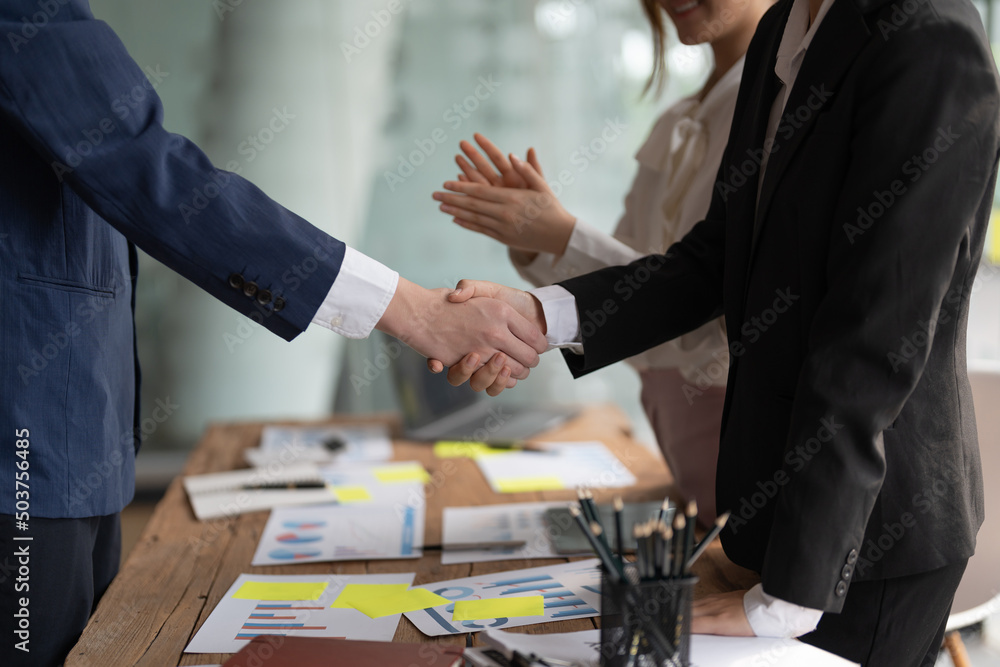 Group business people handshake at meeting table in office together with confident shot from top view . Young businessman and businesswoman workers express agreement of investment deal Group business people handshake at meeting table in office together with confident shot from top view . Young businessman and businesswoman workers express agreement of investment deal