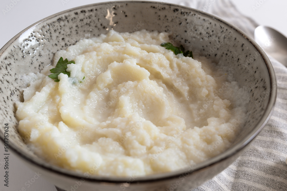 mashed cauliflower puree in bowl. paleo diet. closeup view, selective focus mashed cauliflower puree in bowl. paleo diet. closeup view, selective focus