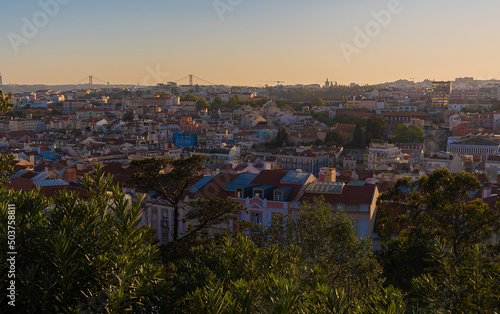 views of lisbon streets and city at sunset. 25 of april bridge