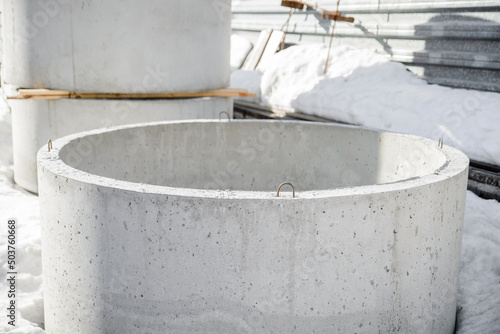 Close-up of the reinforced concrete wall ring of the well stored in the warehouse of the precast concrete factory.