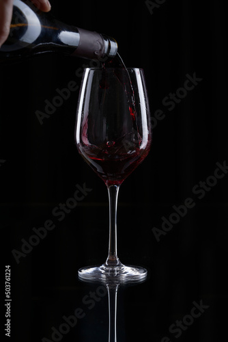 red wine pouring into glass