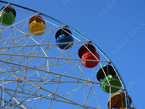 Ferris wheel in retro vintage style. Attraction is the wheel of review on background blue sky