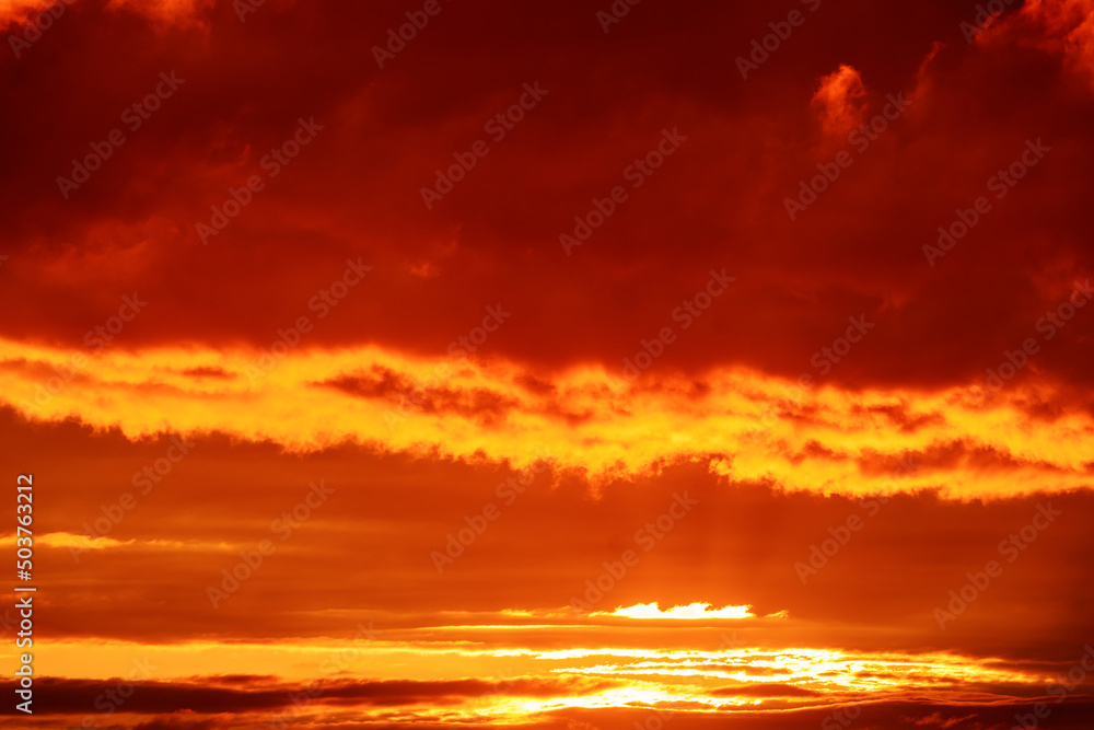 Clouds illuminated by the setting sun. Amazing sky panorama. Mystical lighting. Colorful sunset in the evening sky. Meditative calmness and greatness. Great dramatic view