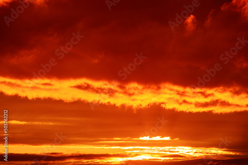 Clouds illuminated by the setting sun. Amazing sky panorama. Mystical lighting. Colorful sunset in the evening sky. Meditative calmness and greatness. Great dramatic view