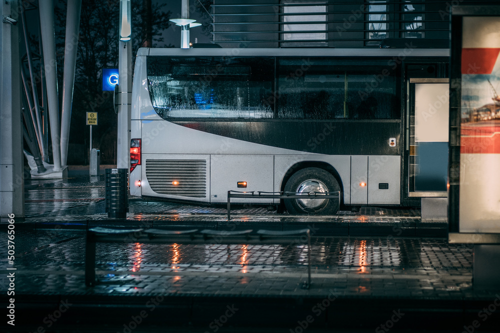 city bus at raining weather at station