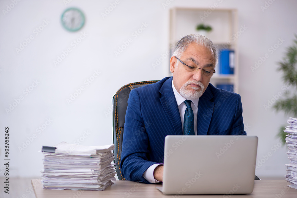 Old male employee and too much work in the office Old male employee and too much work in the office