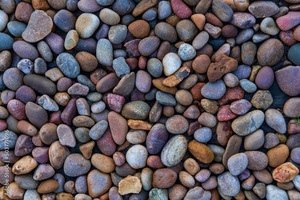 Mineral background featuring river stones in muted colors scattered evenly on the ground, high angle close-up view of small pebbles laid flat, aesthetic mood board backdrop inspiration with copy space Mineral background featuring river stones in muted colors scattered evenly on the ground, high angle close-up view of small pebbles laid flat, aesthetic mood board backdrop inspiration with copy space