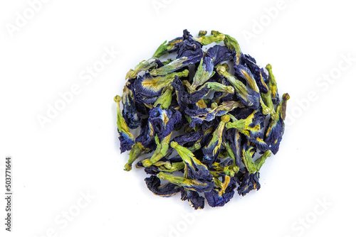 A handful of dried butterfly pea flowers in the shape of a circle on a white background. Blue flower for tea.