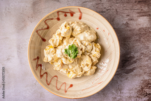 Top shot of cooked pear Fiocchetti on a plate. photo