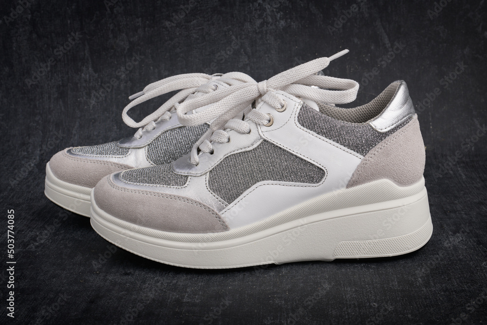 Casual womens sports shoes on gray background close up Casual womens sports shoes on gray background close up