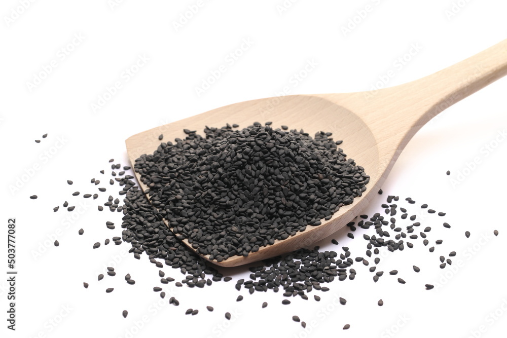 Black sesame seeds pile in wooden spoon isolated on white Black sesame seeds pile in wooden spoon isolated on white