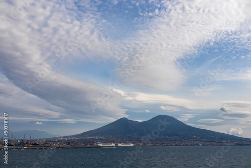 Panoramic view from Castel dell Ovo  Egg Castle  on volcano Mount Vesuvius in Naples  Campania  Italy  Europe. Ferries in the port of Naples. Clouds are accumulating around the mountains. Sea view