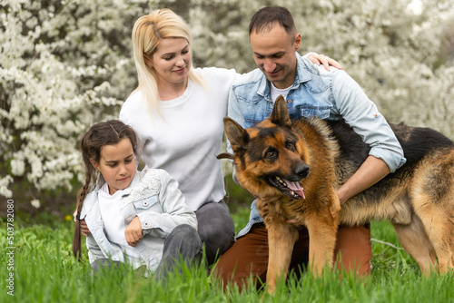 Young family with children and with dog having fun in nature