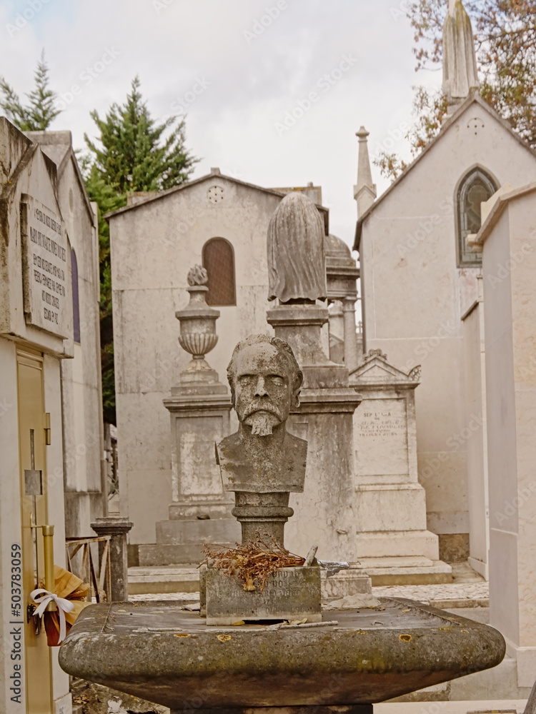 Fototapeta premium Gravetomb with bust of a sad man in Alto de Sao Joao cemetery, Lisbon, Portugal 