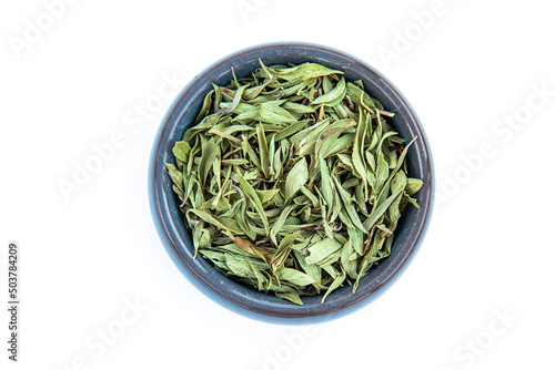 Small blue bowl with tea and dry thyme leaves on a white background,top view.