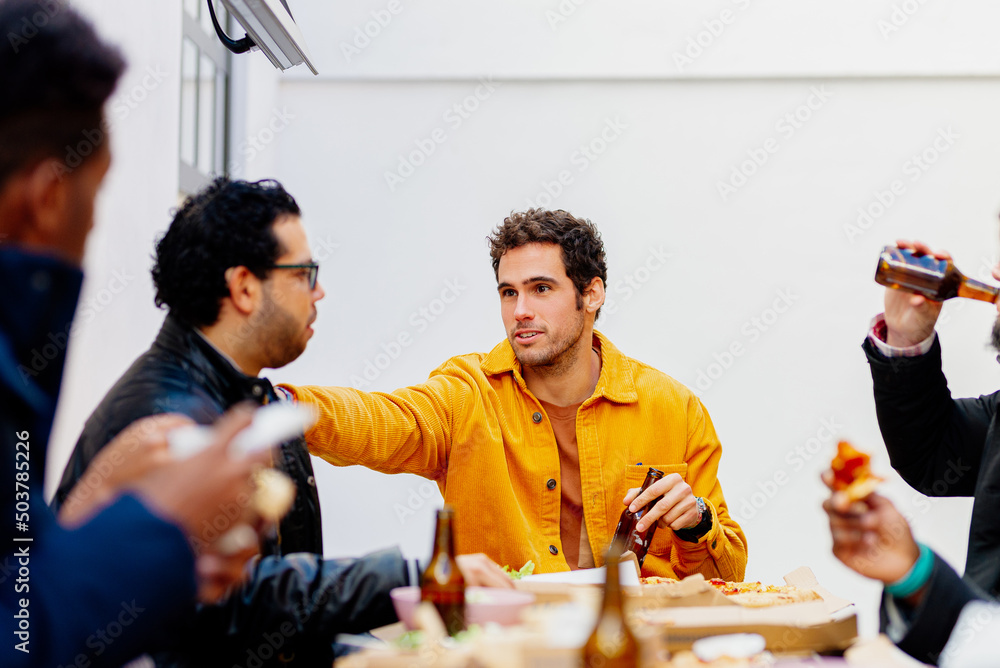 multiracial group of friends celebrating a meal together in a restaurant. multiracial group of friends celebrating a meal together in a restaurant.