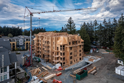 Halfway ready wood framing of a new six story apartment building at construction site in the city
