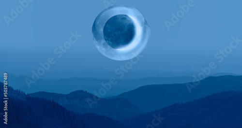  Beautiful landscape with blue misty silhouettes of mountains against A crescent in a crystal moon"Elements of this image furnished by NASA" © muratart