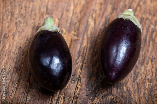 two small eggplants on wood