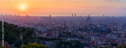 Panoramic view on the sunrise above Barcelona city in Spain. Sagrada Familia among all other architecture and buildings. Travel photography. Best destination for tourists in Europe.