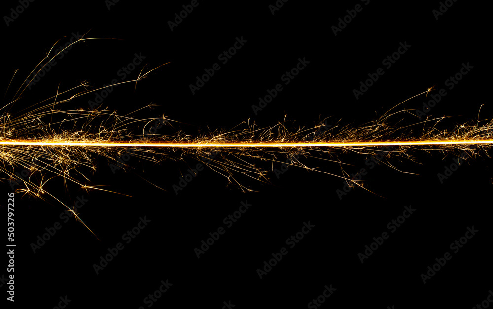 Sparkler trail of light with sparks in a straight line Sparkler trail of light with sparks in a straight line