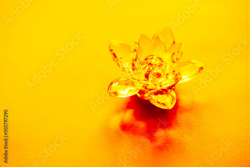 Crystal lotus on yellow table. Manipura chakra symbol photo