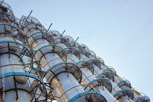 Фотография Oil refinery chemical plant wide view with copyspace over blue evening sky with clouds background