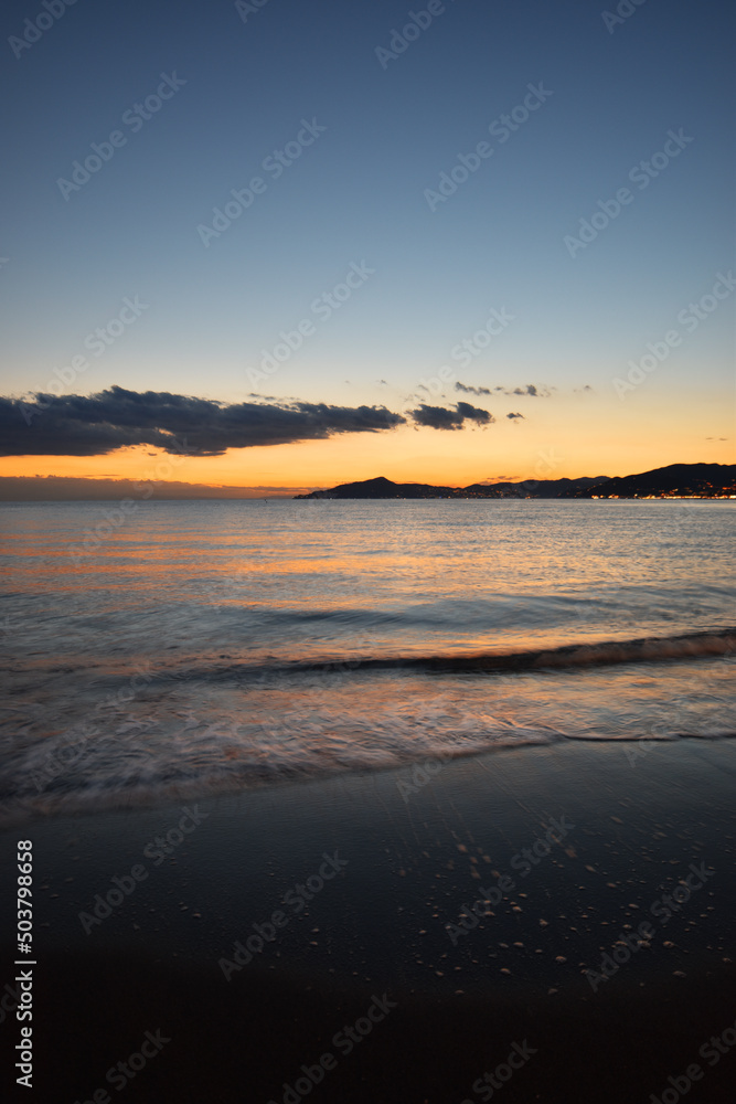 incredible colors and lights, a romantic sunset on the beach facing the sea in the magnificent Liguria incredible colors and lights, a romantic sunset on the beach facing the sea in the magnificent Liguria