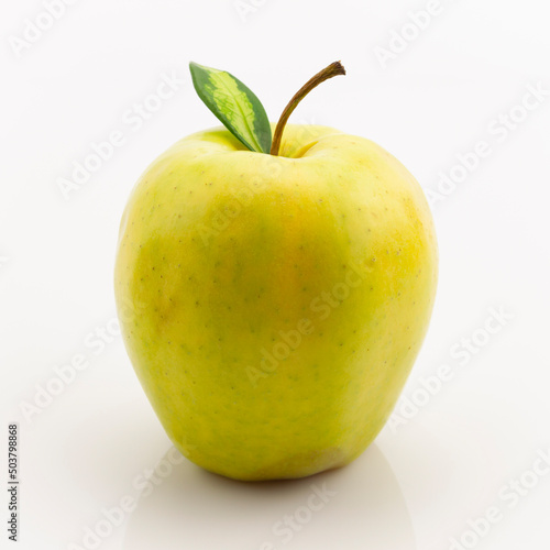 One ripe yellow apple fruit with green leaf isolated on white background with clipping path