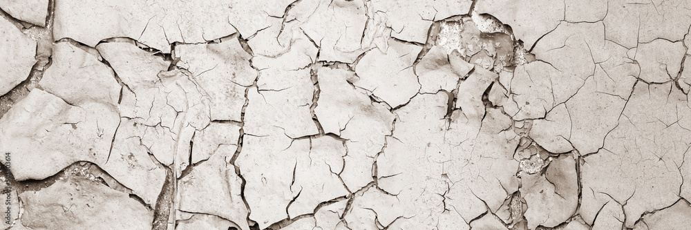 Peeling paint on the wall. Panorama of a concrete wall with old cracked flaking paint. Weathered rough painted surface with patterns of cracks and peeling. Wide panoramic grunge texture for background Peeling paint on the wall. Panorama of a concrete wall with old cracked flaking paint. Weathered rough painted surface with patterns of cracks and peeling. Wide panoramic grunge texture for background