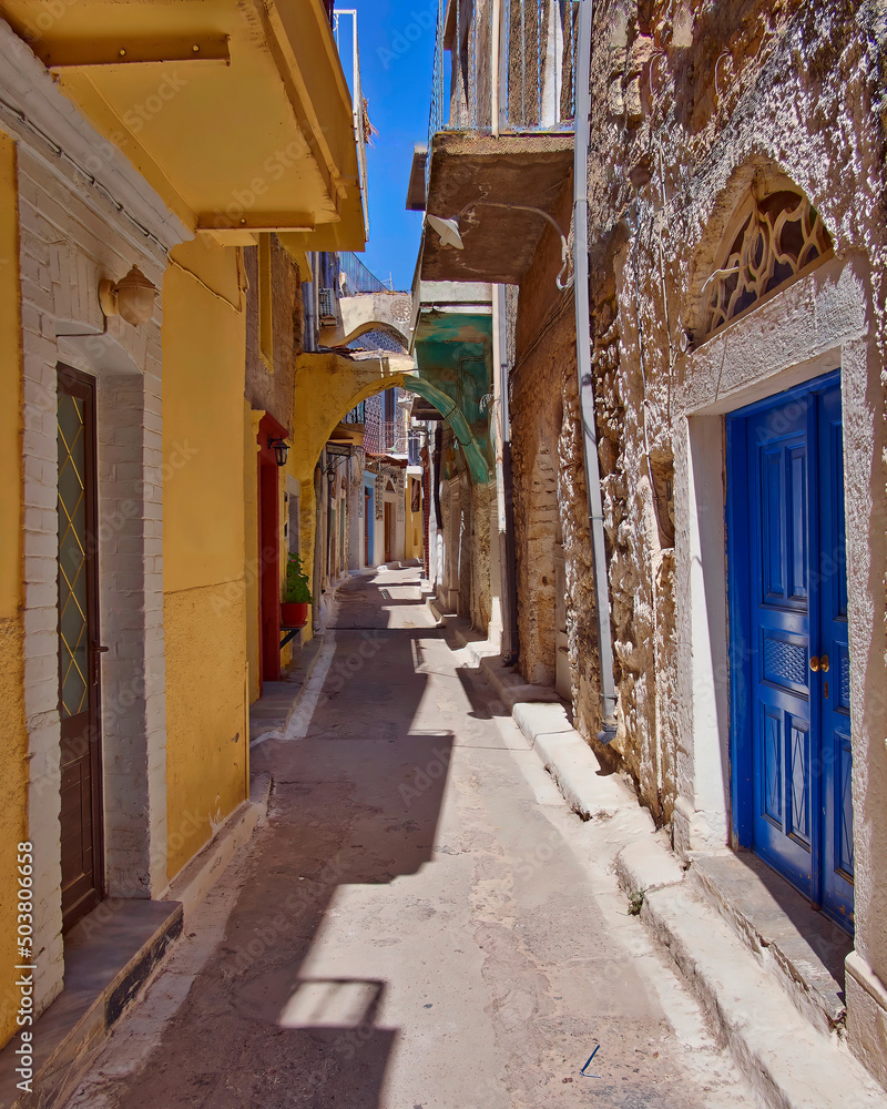 Old houses with colorful walls and doors by a picturesque alley, Chios island, Greece