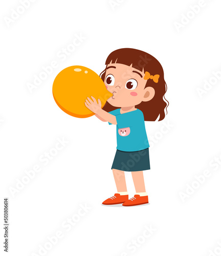 little kid standing and blowing a balloon