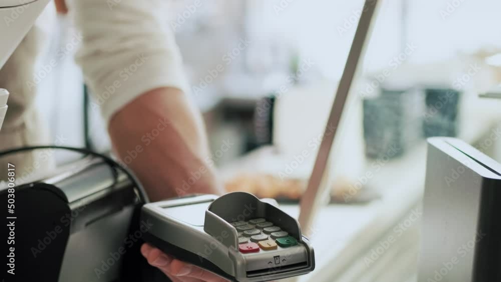 Video of customer using her credit card to make payment with electronic reader in the restaurant. Video of customer using her credit card to make payment with electronic reader in the restaurant.