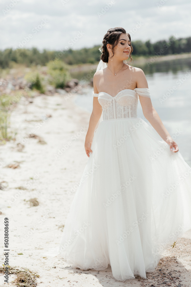 beautiful young woman with flowers.summer girl. bride near a lake