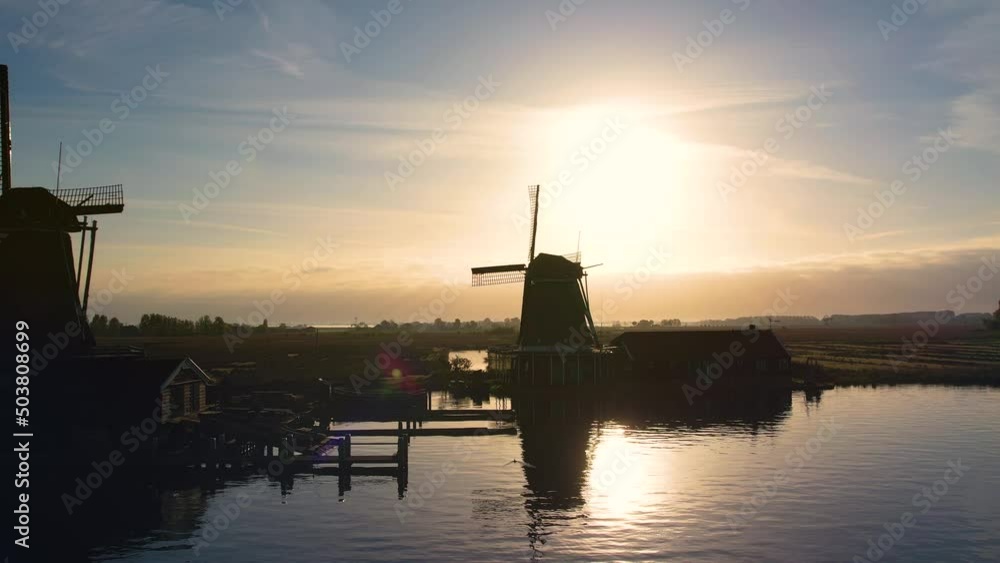 Windmills at Zaanse Schans, aerial view. Famous place to visit in Amsterdam, Netherlands. Dutch Mills and typical Holland landscape in spring or summer, sunny weather. Windmills at Zaanse Schans, aerial view. Famous place to visit in Amsterdam, Netherlands. Dutch Mills and typical Holland landscape in spring or summer, sunny weather.