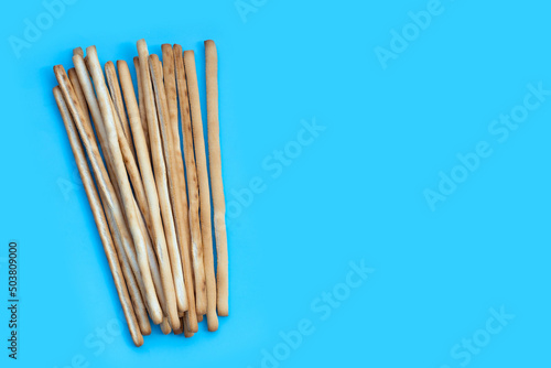 Bread sticks on blue background