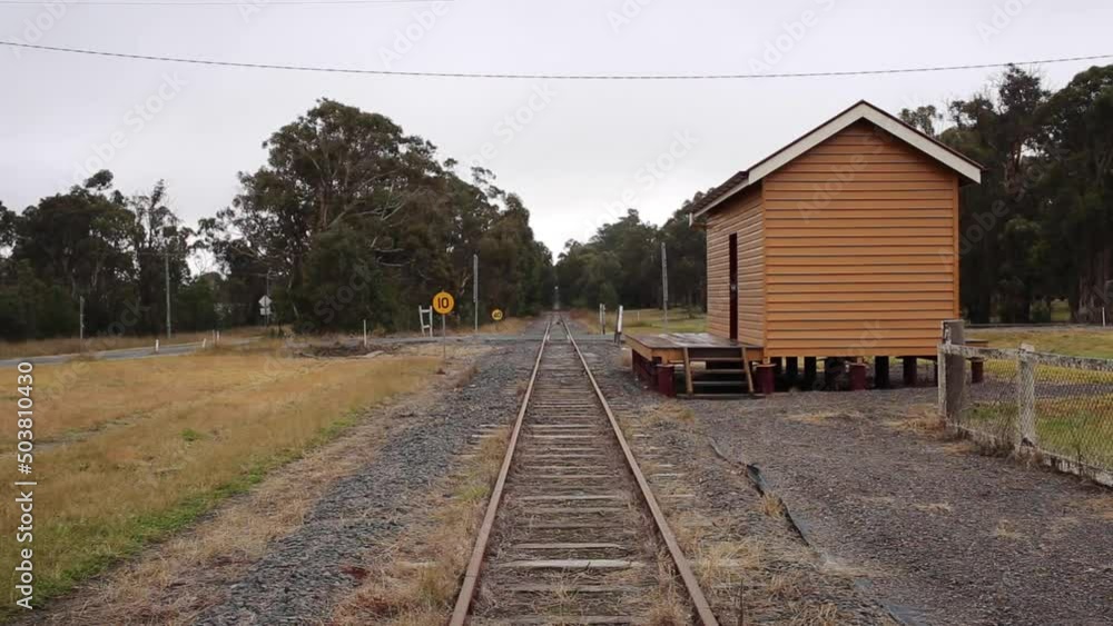Old railway station in village setting looking down tracks.