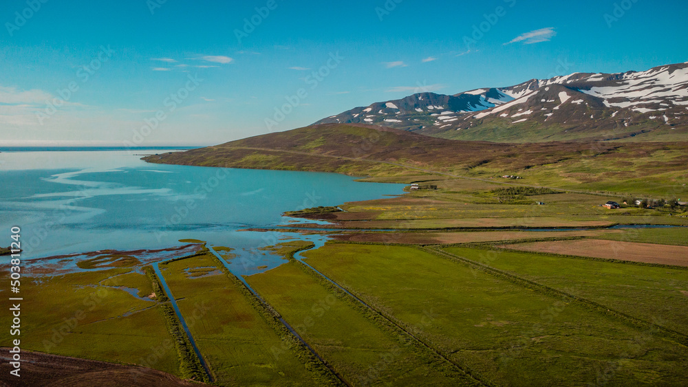 Beautiful valley of Miklavatn lake close to Haganes with aerial drone view of river delta and beautiful Icelandic hills and mountains in the background.