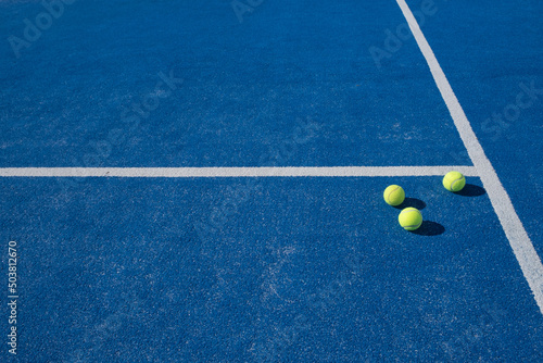 Selective focus. Three balls an the net of a paddle tennis court © Vic