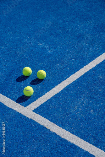 three balls on a paddle tennis court, selective focus,  © Vic